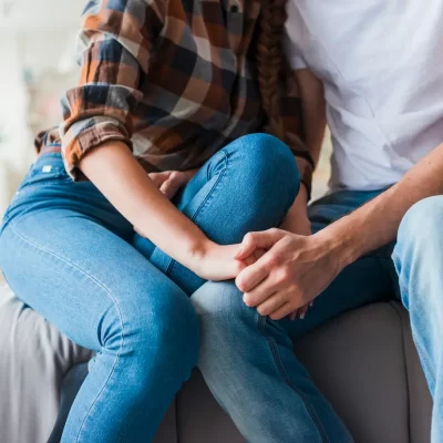 couple-love-holding-hands-sofa